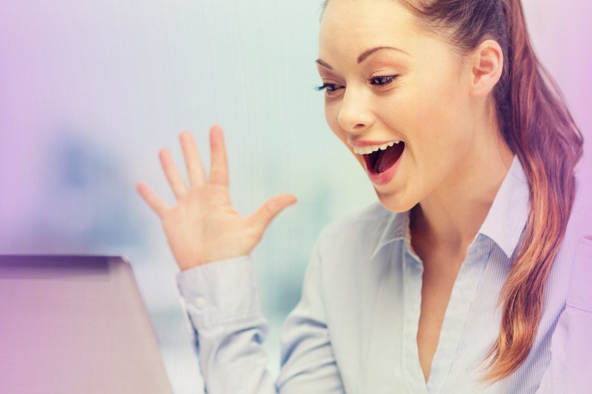 A client reacting with delight at something on her laptop screen